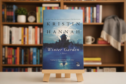 Book cover of 'Winter Garden' by Kristin Hannah with a silhouette of a house on a lake.