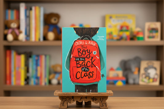 Book cover of 'The Boy at the Back of the Class' with a red backpack and turquoise background