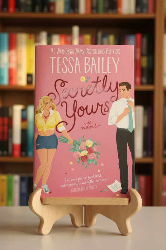 Book cover of 'Secretly Yours' by Tessa Bailey on a pink background